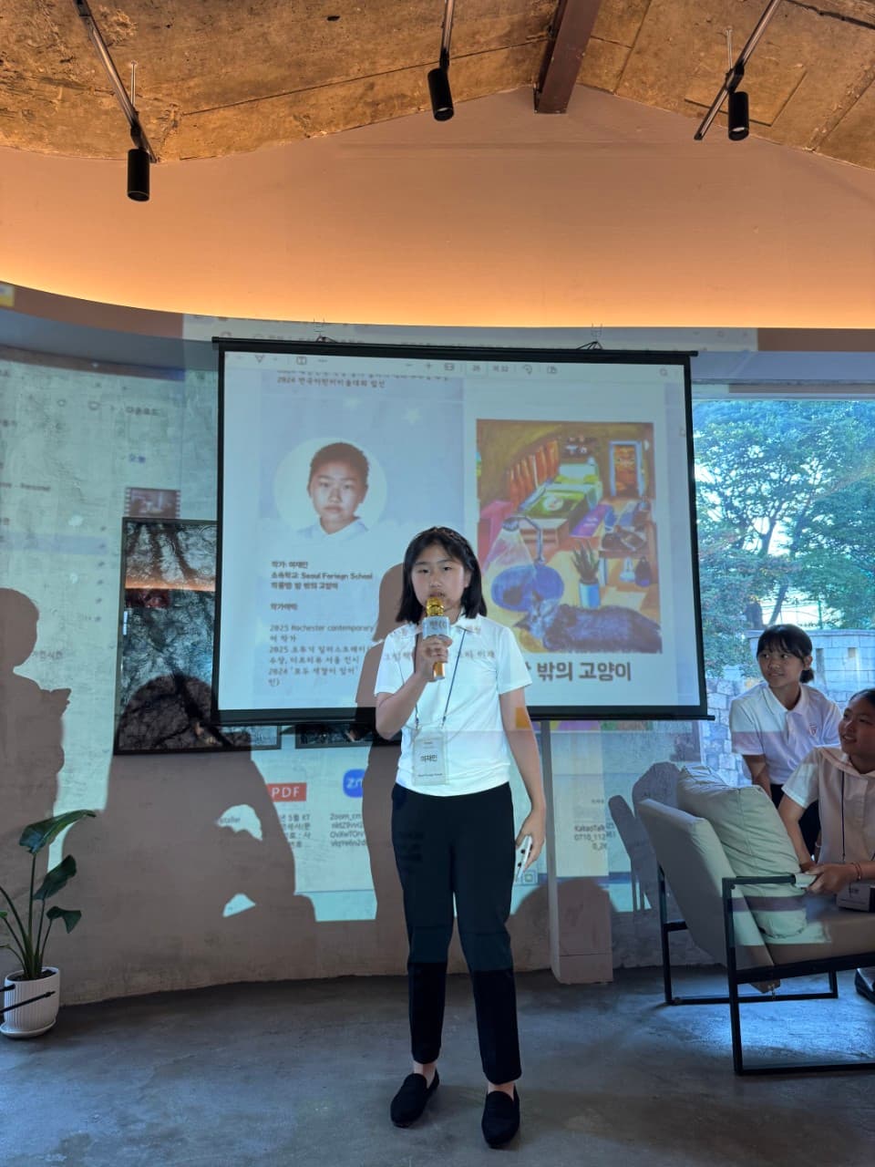 A young artist presenting her work with a microphone