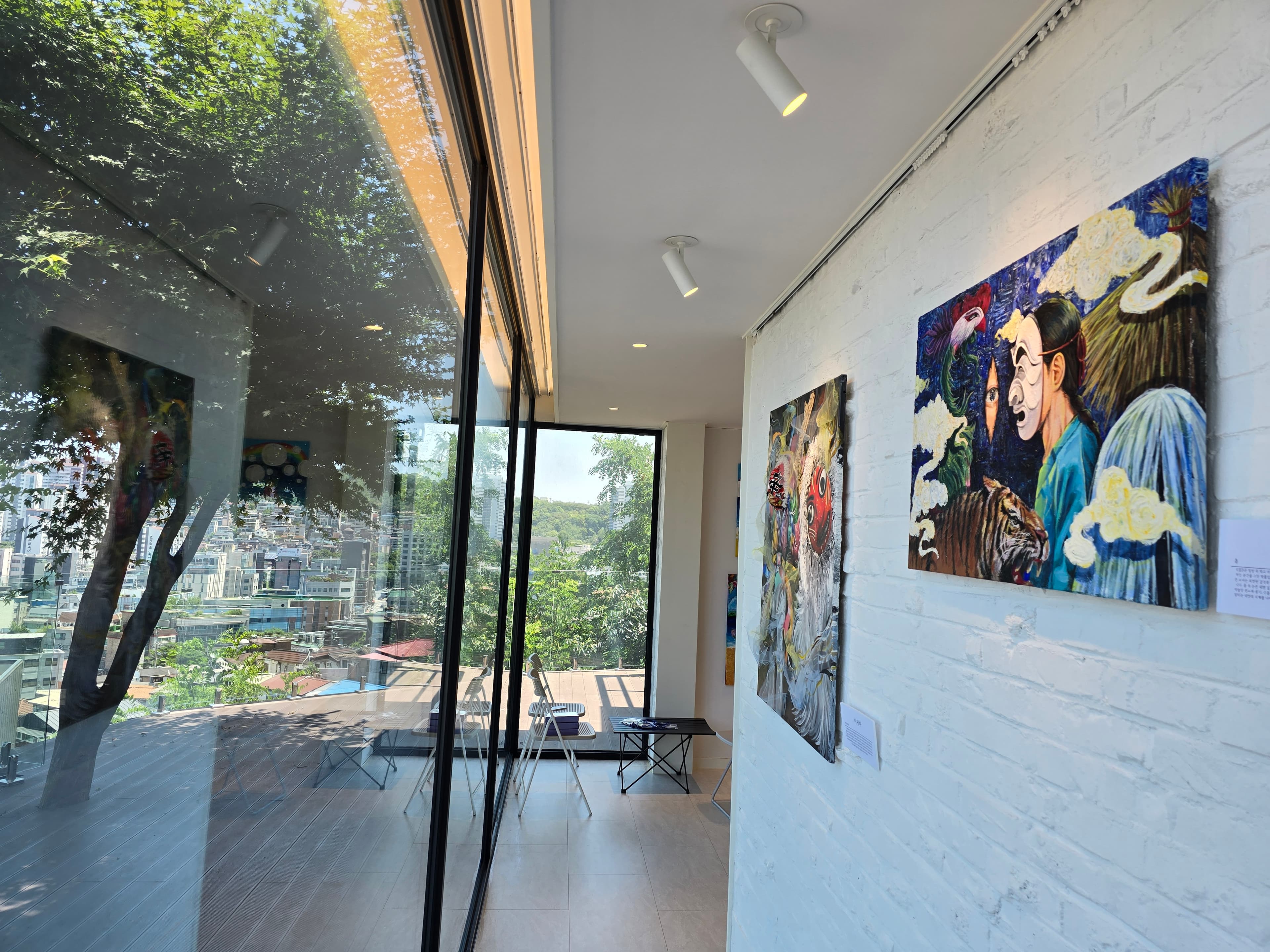 Artworks lit by natural light in the gallery space